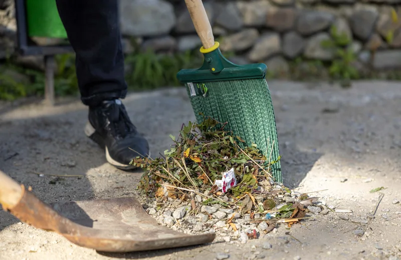 Gathering leaves and garden debris with a rake